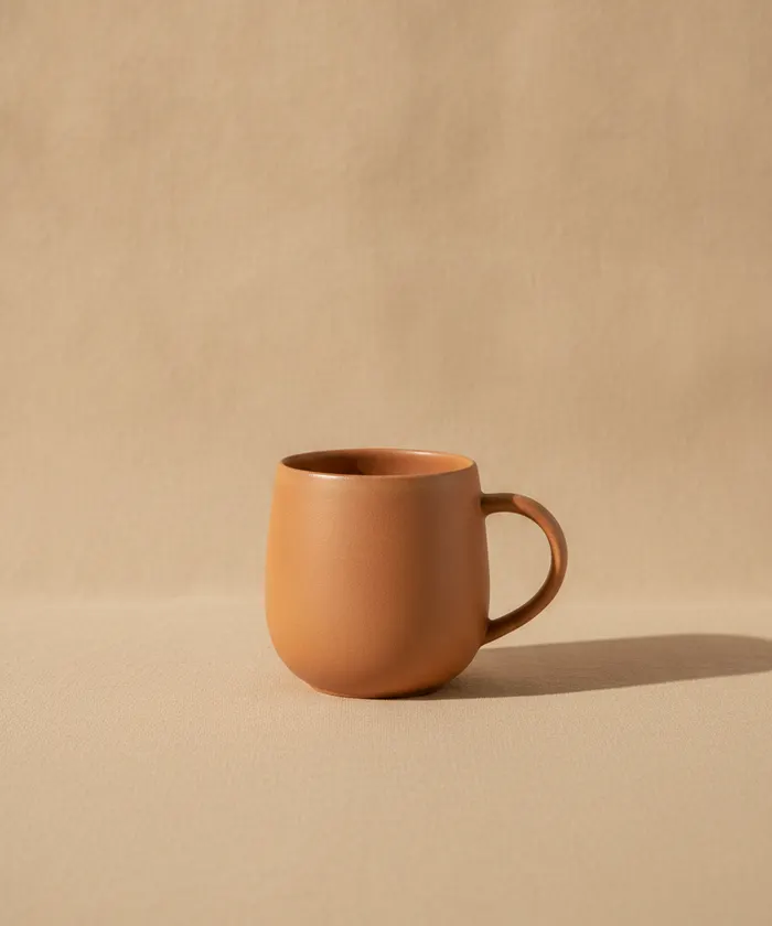 A fired terracotta mug